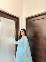 Aqua Silk Sharara Set by MONA featuring a three-piece design with intricate detailing and flowing fabric.